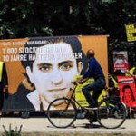 BERLIN, GERMANY - JUNE 11: A cyclist passes as activists demonstrate outside the Saudi Arabian Embassy against the recent Saudi court ruling that upheld a previous verdict of ten years in prison and 1,000 lashes for Saudi blogger Raif Badawi on June 11, 2015 in Berlin, Germany. The court accuses Badawi of insulting Islam in an Internet forum. (Photo by Carsten Koall/Getty Images)